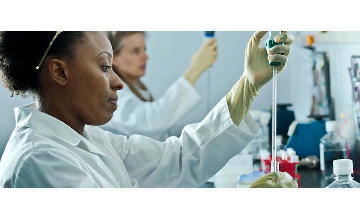 Scientists pipetting in a laboratory