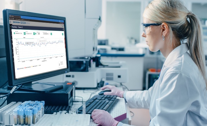 Female scientist reviewing data on a desktop device